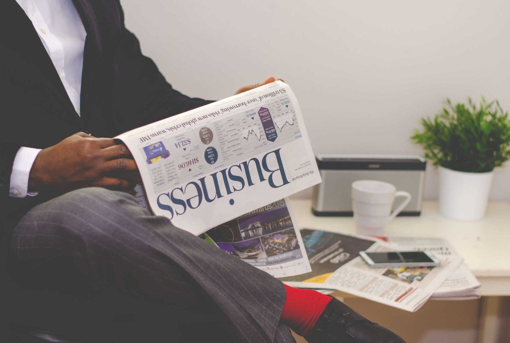 A person reading a business newspaper for successful change management.