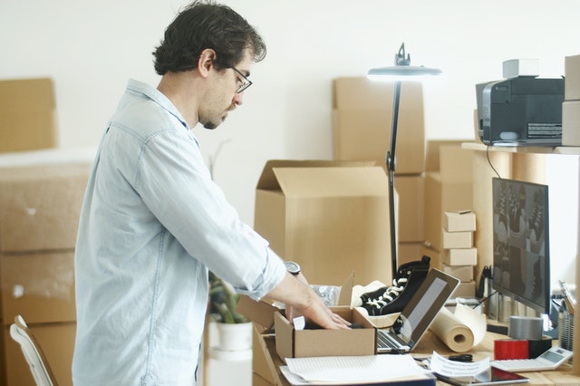 a man compiling an inventory list of items in a self-storage