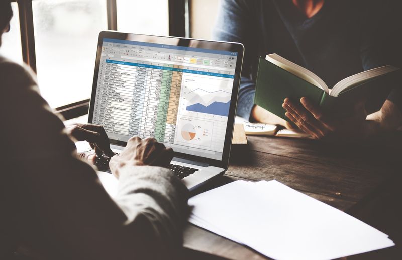  A business person working with a spreadsheet on his laptop