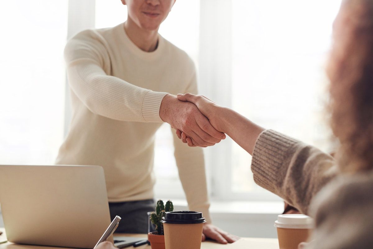 people shaking hands at a meeting