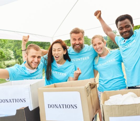 A Business’s Complete Guide To Non-Profit Fundraising Volunteer volunteers cheer at a charitable fundraiser